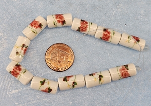 Set of 11 ceramic cylinder flower beads measuring 16mm x 8mm